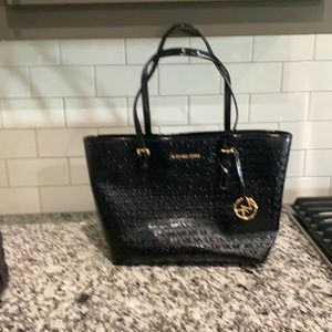 Black Michael Kors purse with tags